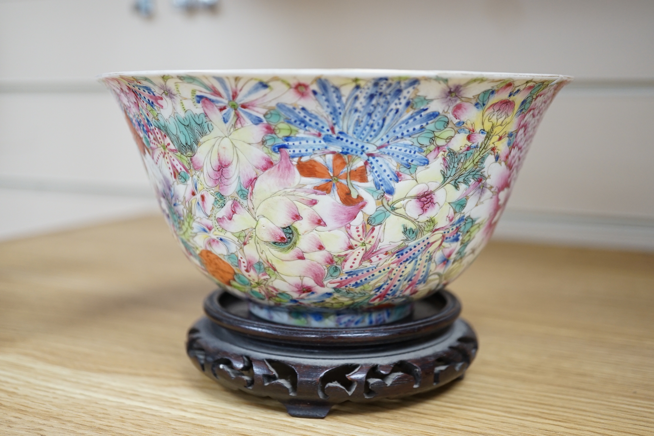 A Chinese 'Thousand Flower' enamelled porcelain bowl, Qianlong mark, early 20th century on hardwood stand, 17cm high